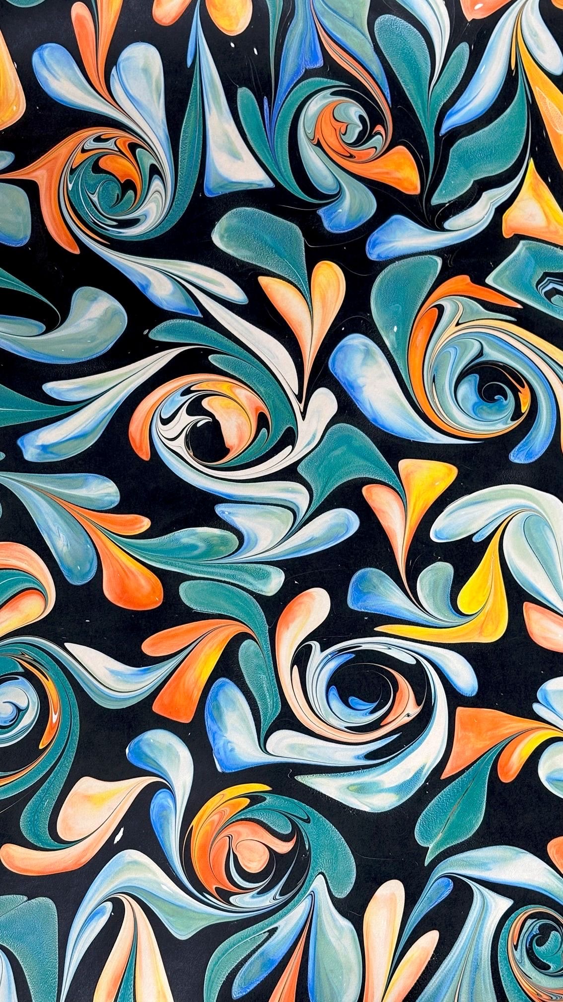 Marbled paper: teal, orange, and cream swirls on black.